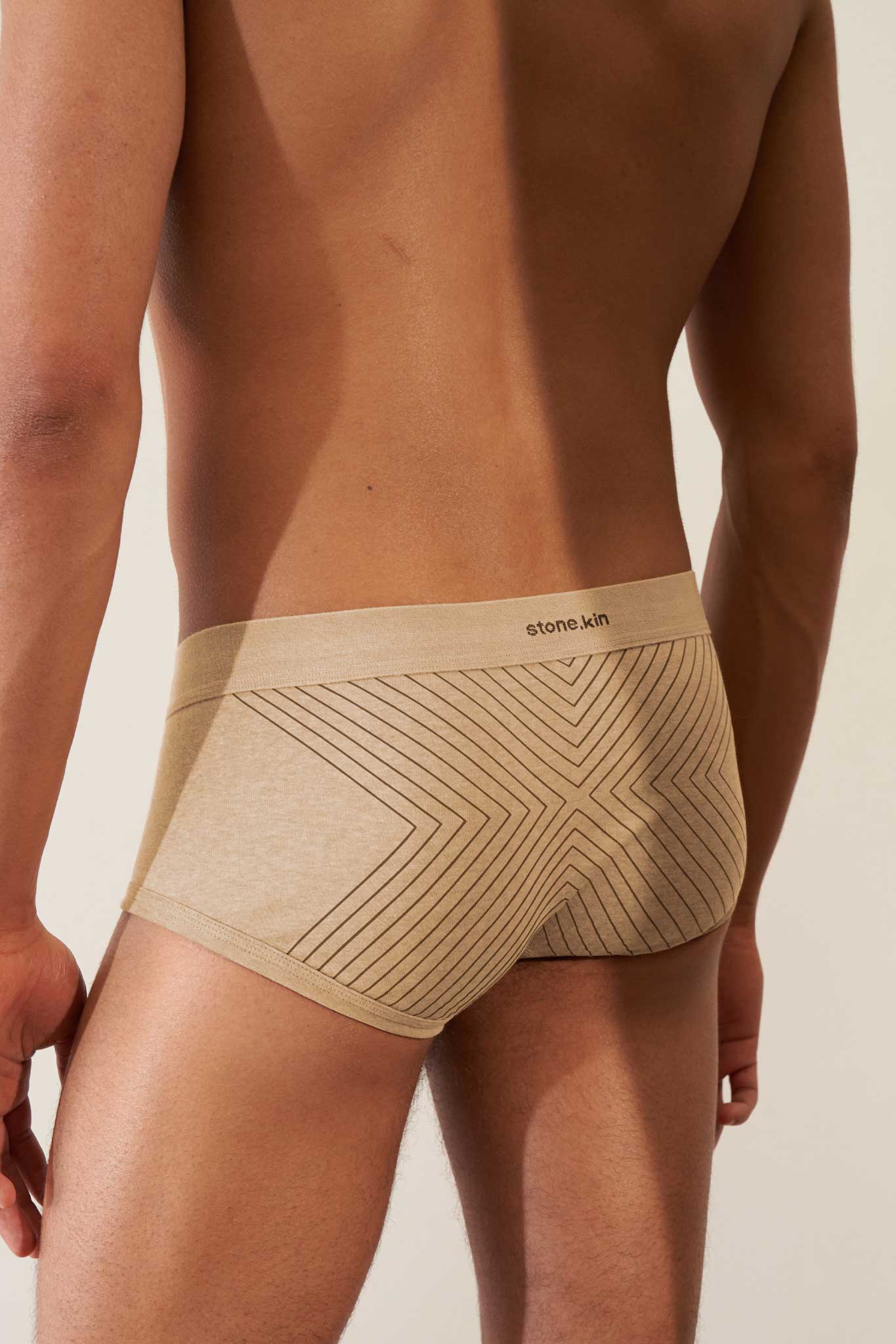 Trunk in organic cotton rib, sand color with Tar Cross stripes, showcasing comfort and GOTS certified non-toxic fabric.